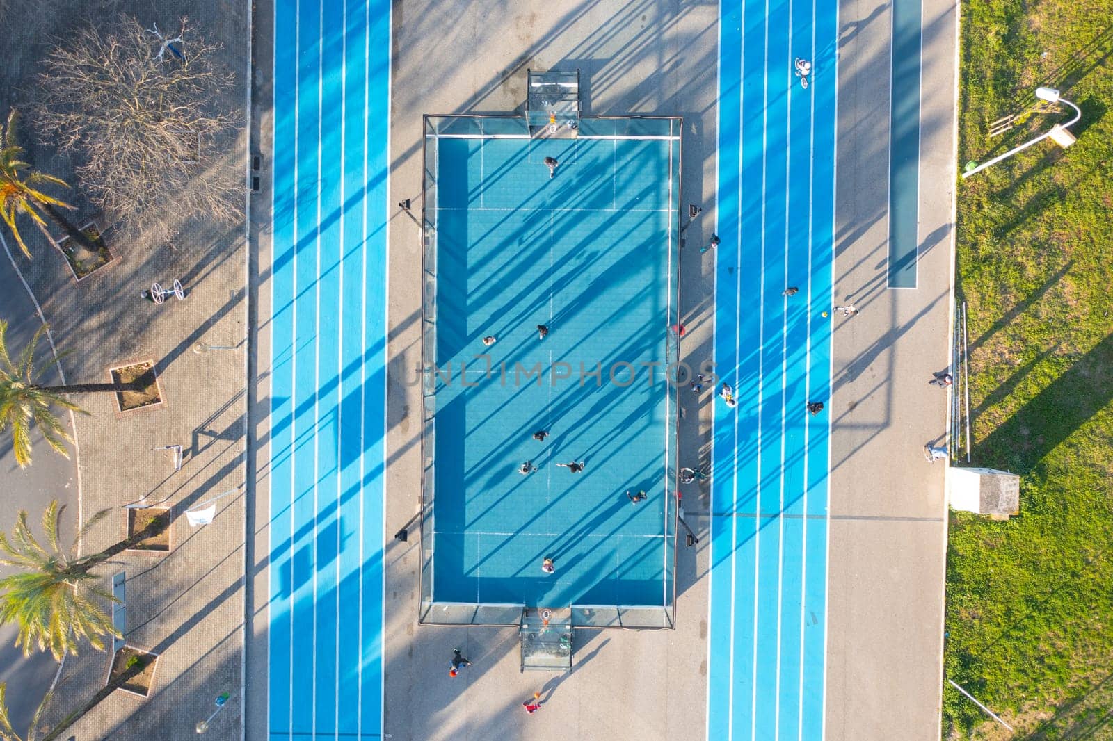 Aerial view of blue artificial football and basketball field. by andreonegin