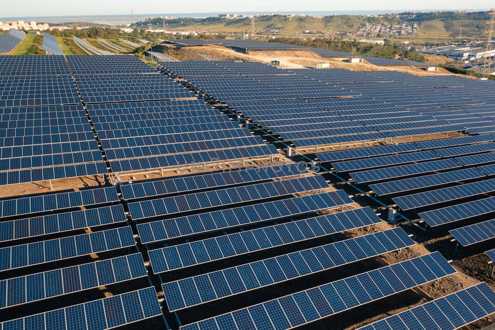 Solar panels on farmland producing green energy for houses by andreonegin