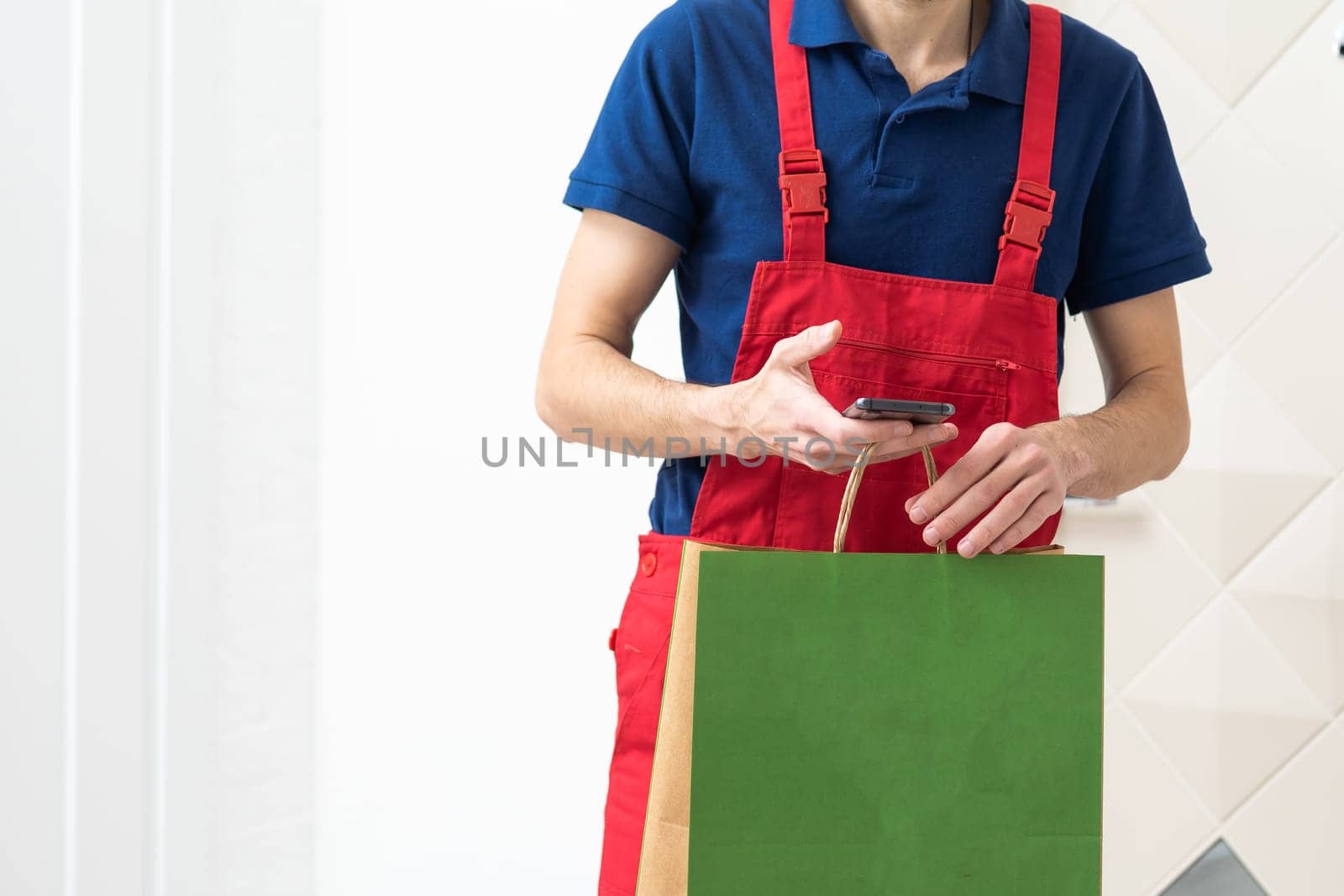 Diverse of paper containers for takeaway food. Delivery man is carrying. High quality photo