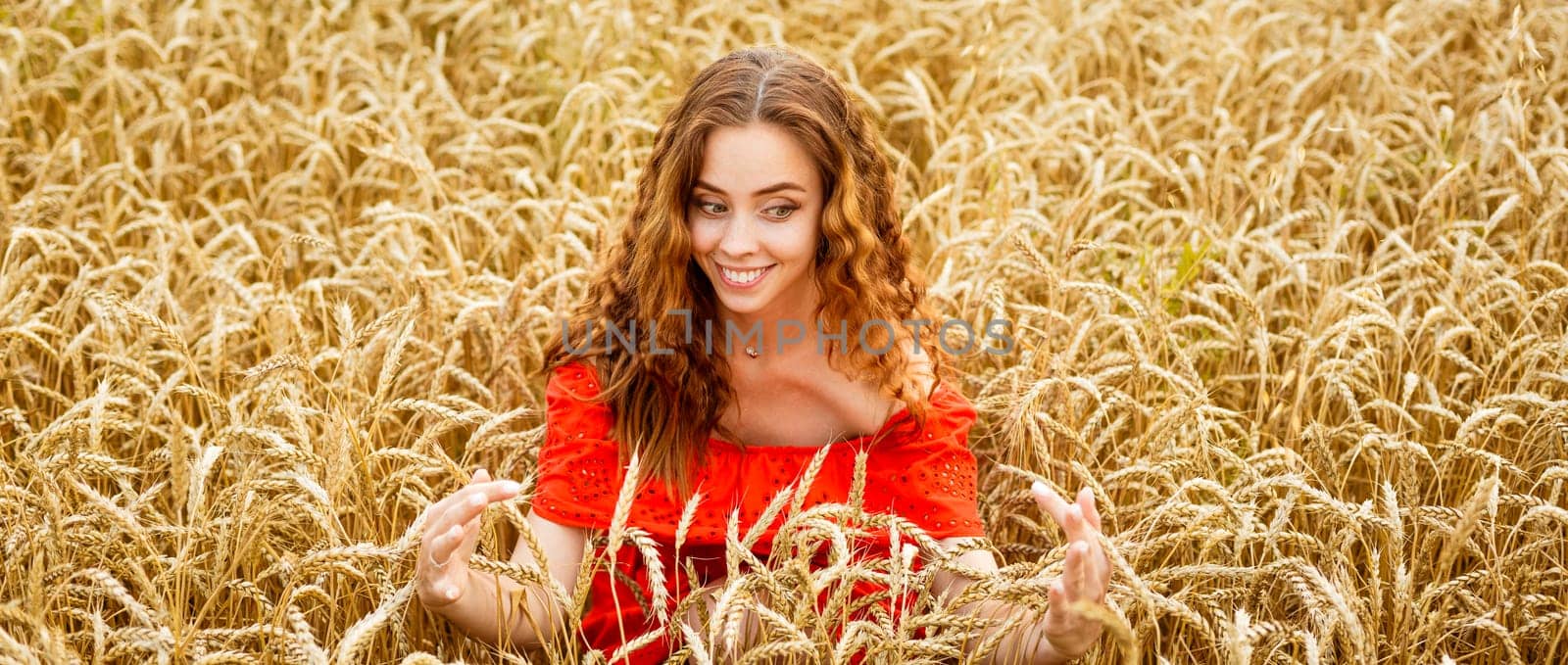 Style redhead young woman in red clothes tay view yellow wheat nature Cute girl smiles with a snow-white toothy smile. Natural beauty on a natural background. Caucasian real girl.