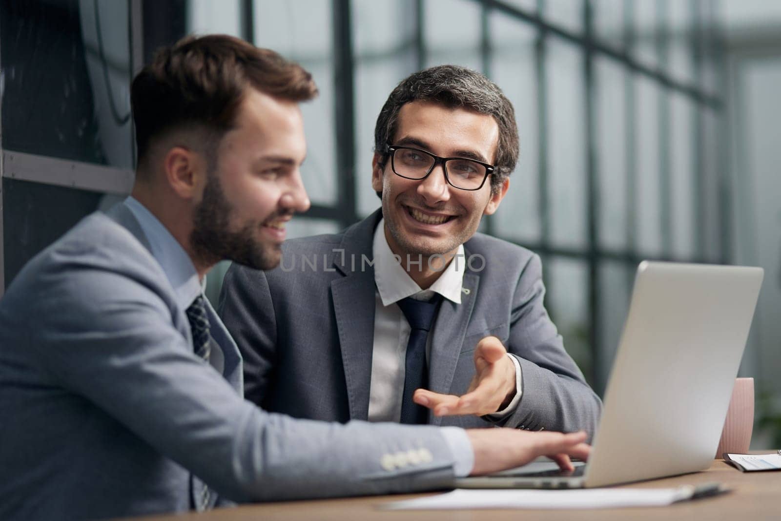 Businessmen discussing deal, sharing startup ideas, business partners negotiations or job interview in modern office