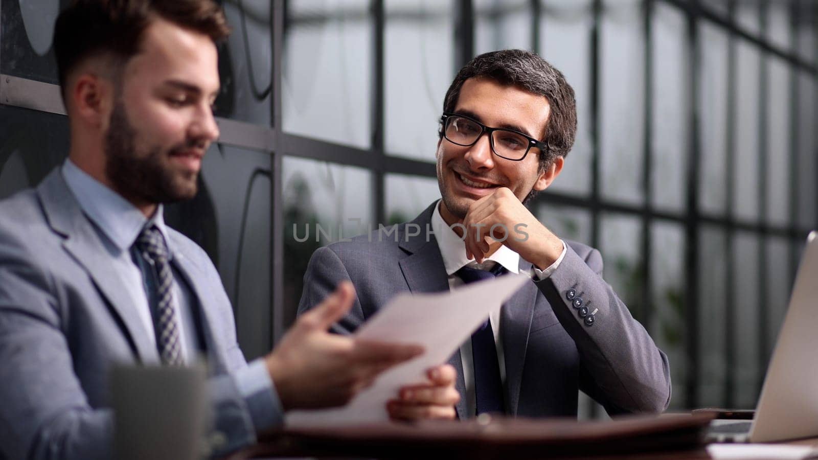 business colleagues sitting at a desk in a modern office