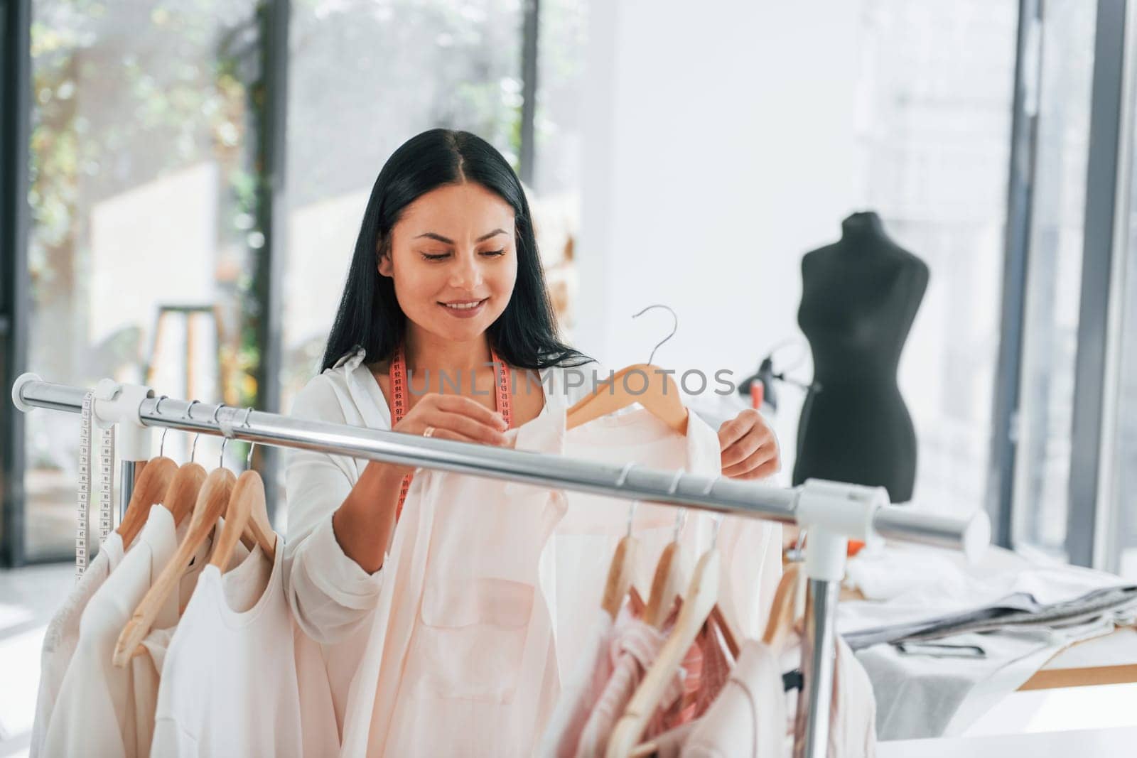 Looking for shirt. Seamstress is in her office that is with different clothes.