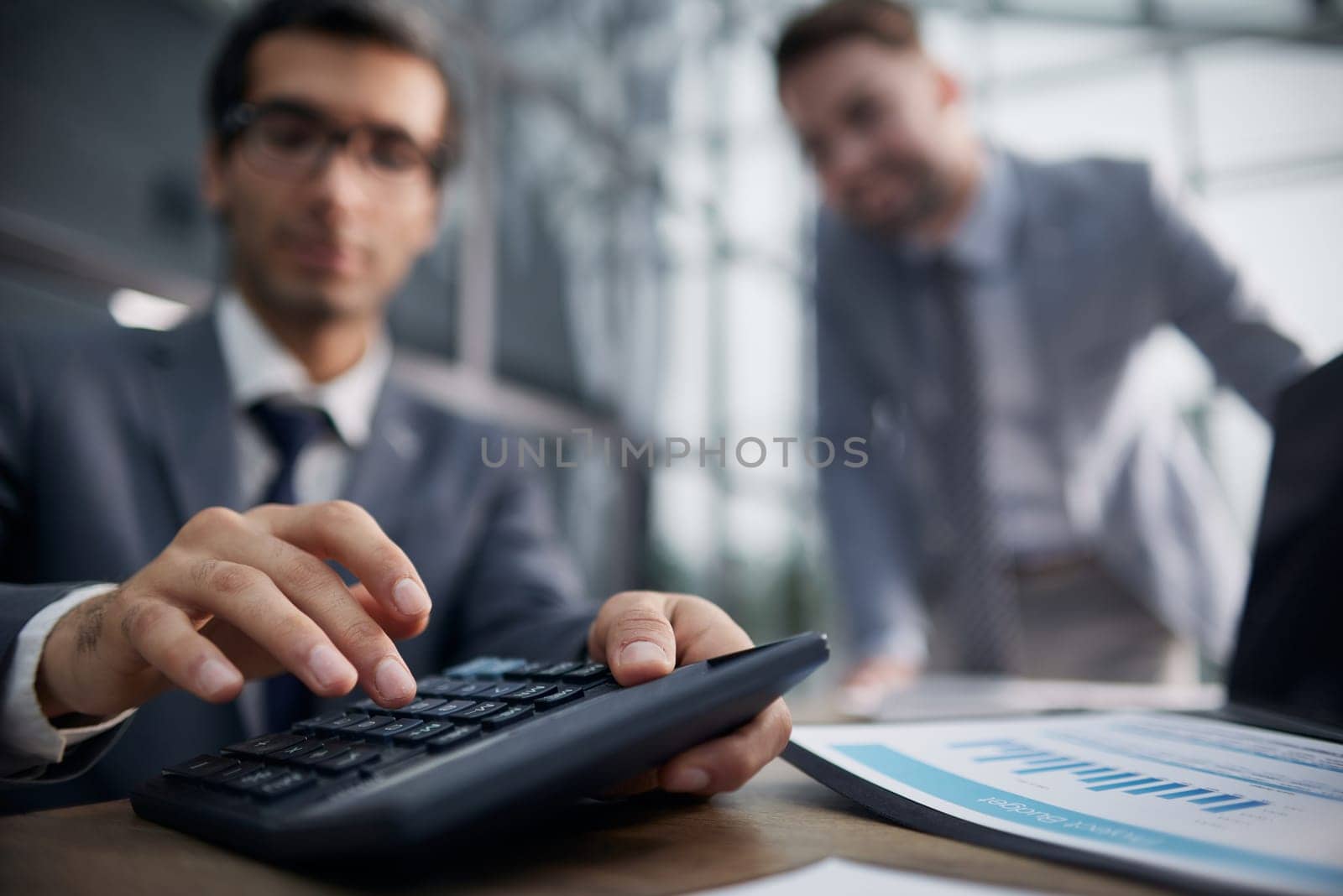 businessman uses a calculator for calculations in the office