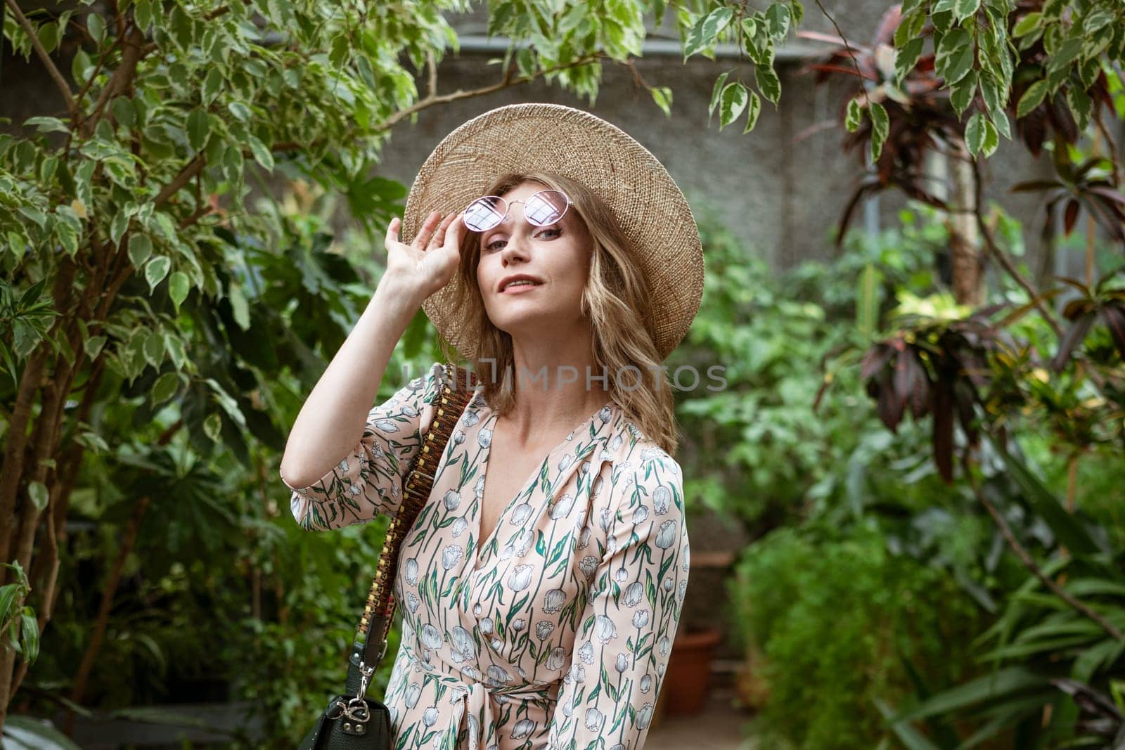 cute young blonde woman in the greenhouse by EkaterinaPereslavtseva