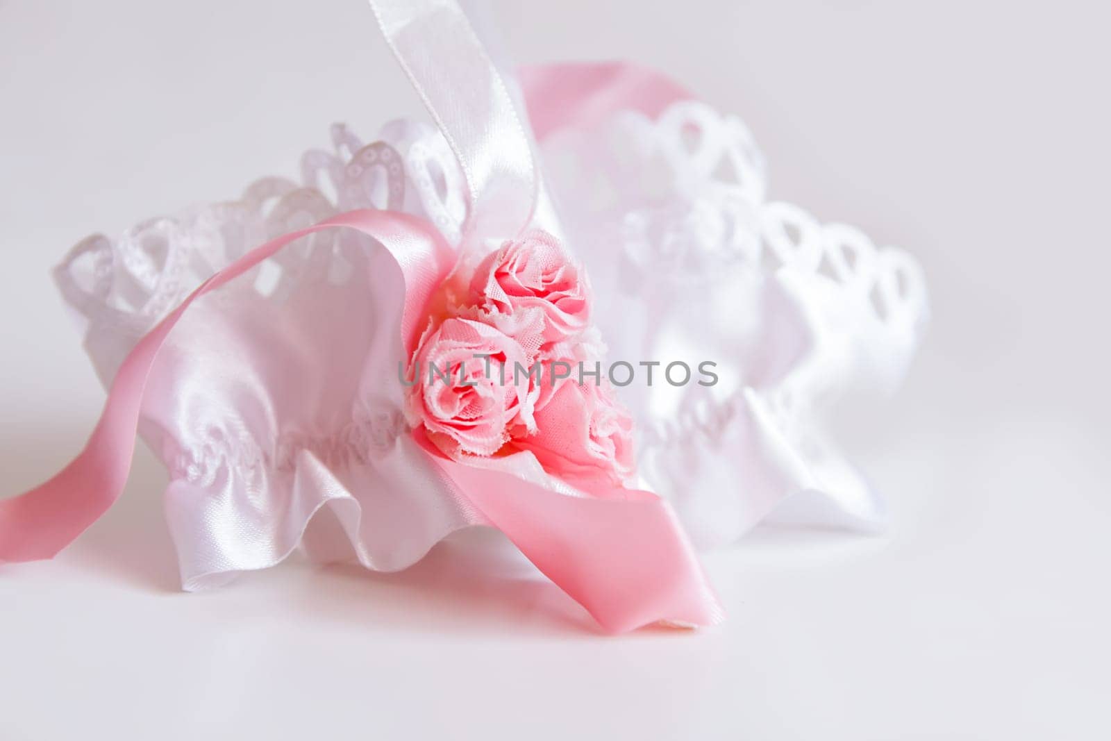 The bride's garter on a pink background. by nightlyviolet