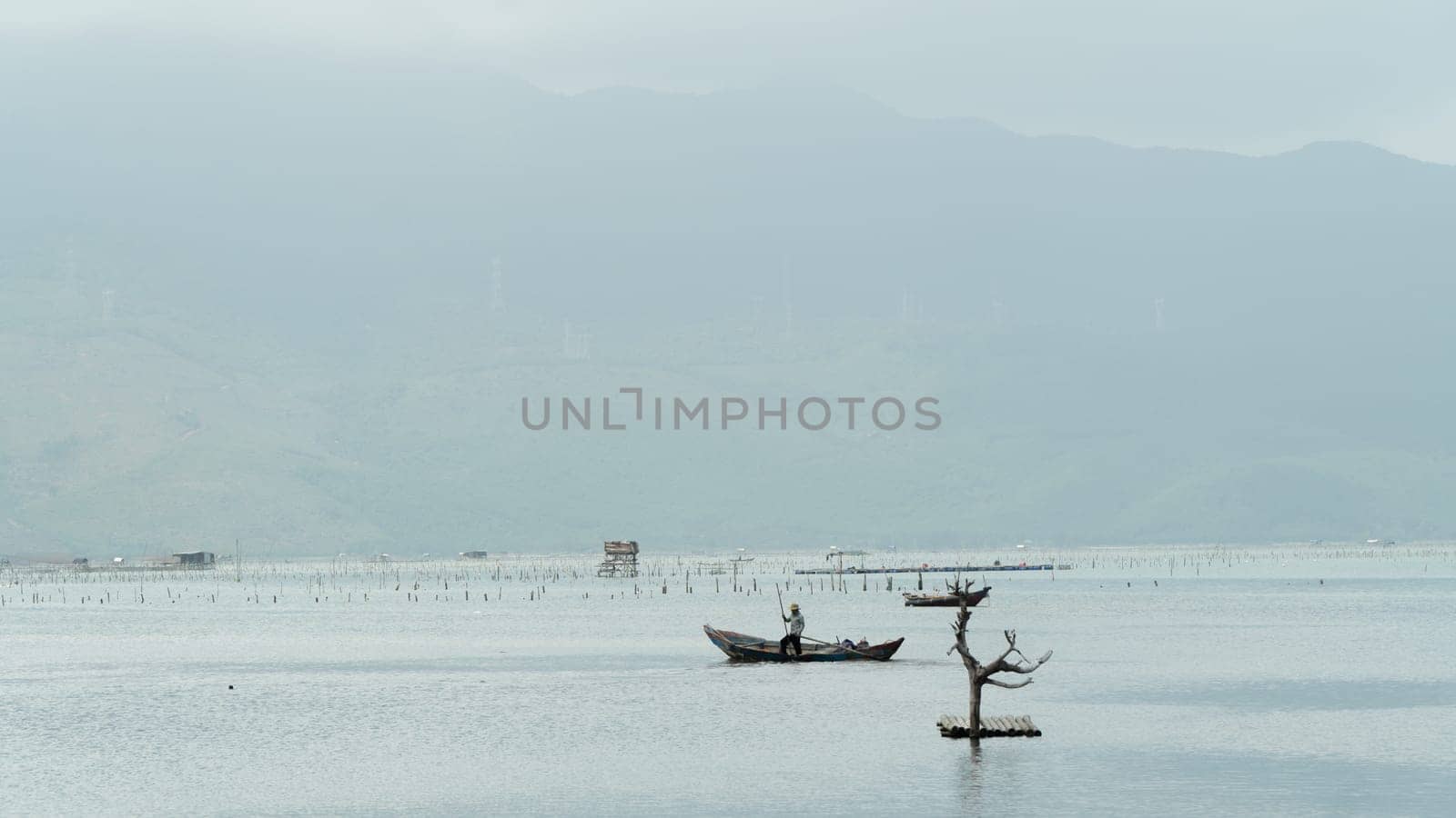 Fisherman in a boat on the river background. High quality photo