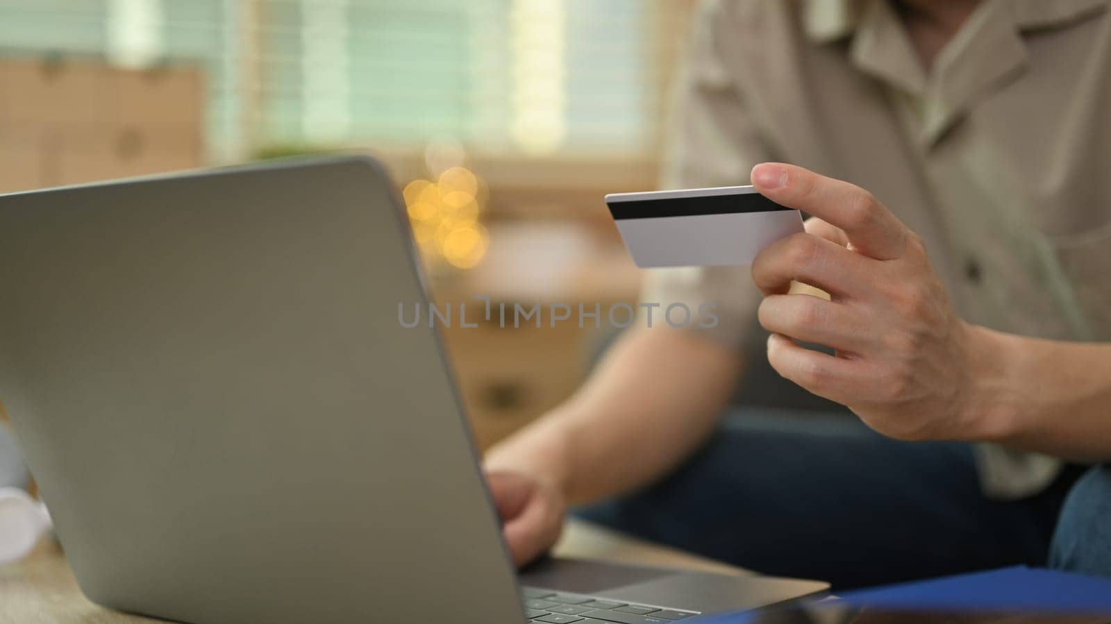 Man holding credit card and using mobile phone for online banking transaction. Business financial and technology by prathanchorruangsak