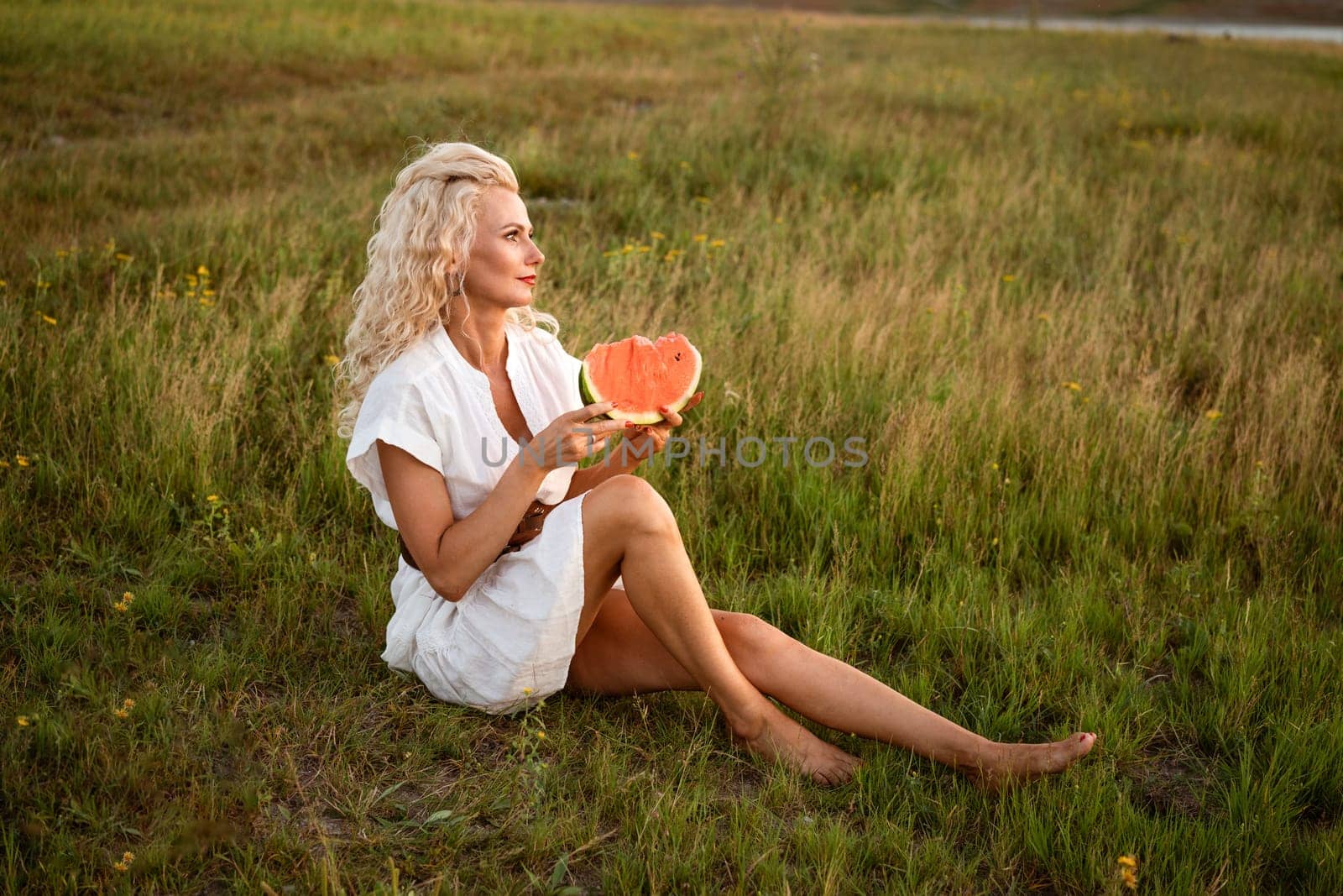 Portrait of a happy young woman enjoying and eating watermelon outdoors, slow life. Summer lifestyle concept. Happiness, joy, holiday independence day.