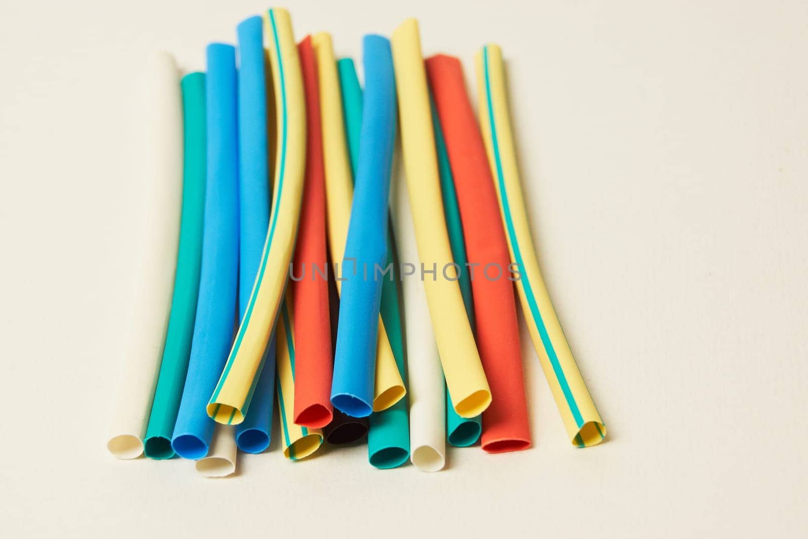 Multicolored shrink tube on a white background tubes of different colors