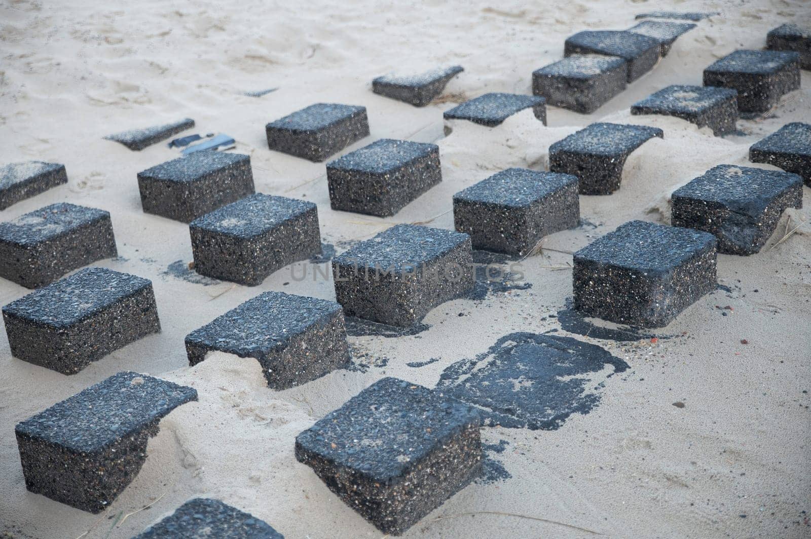 square granite blocks on the beach to reinforce the coast by compuinfoto