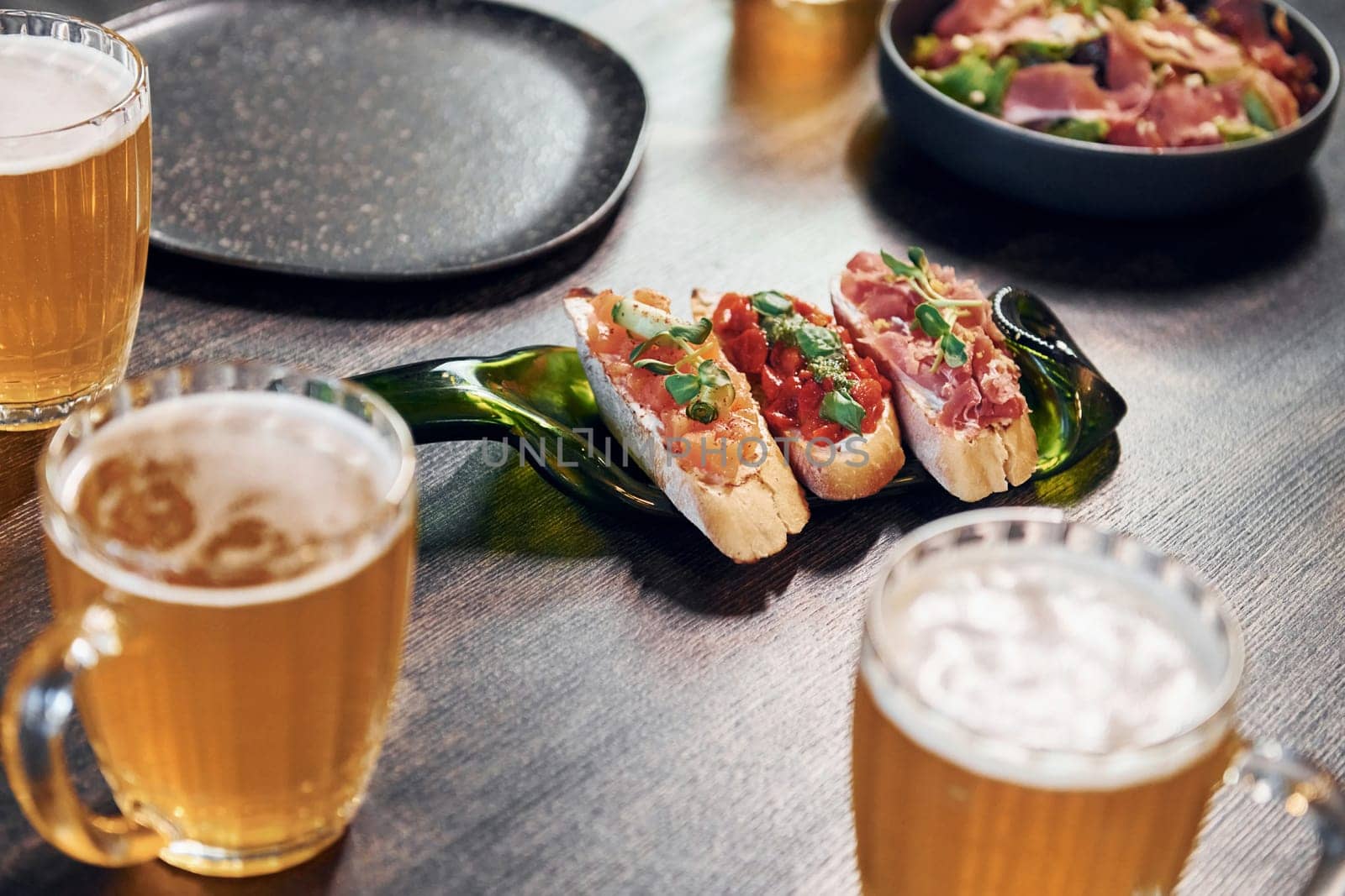 Close up view of food and beer on the table.