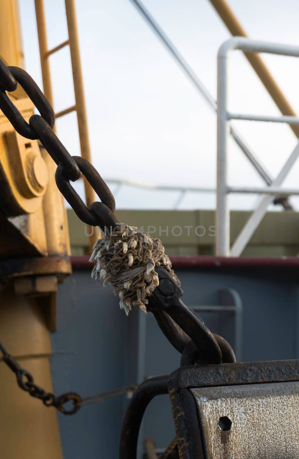 detail of an old rusty chain attachment on a fishing vessel