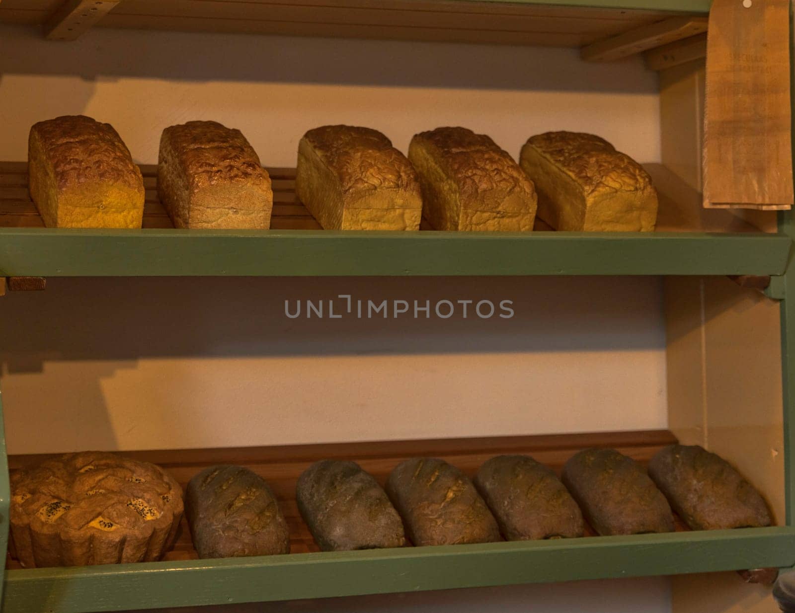 wooden shelfs in a old bakery shop with different kind of bread