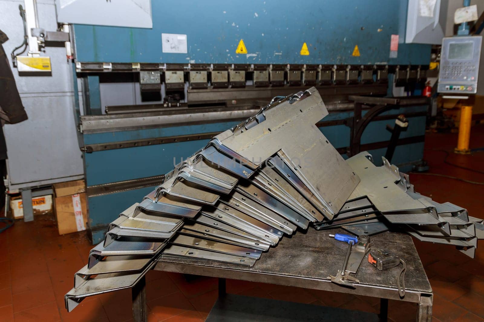 A stack of sheet metal products after processing on a bending machine.