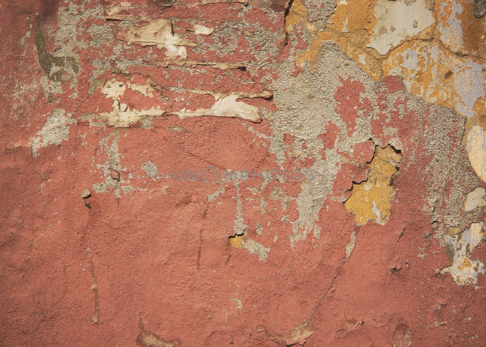 Old concrete wall with crumbling paint and yellow paint, backgrounds, textures