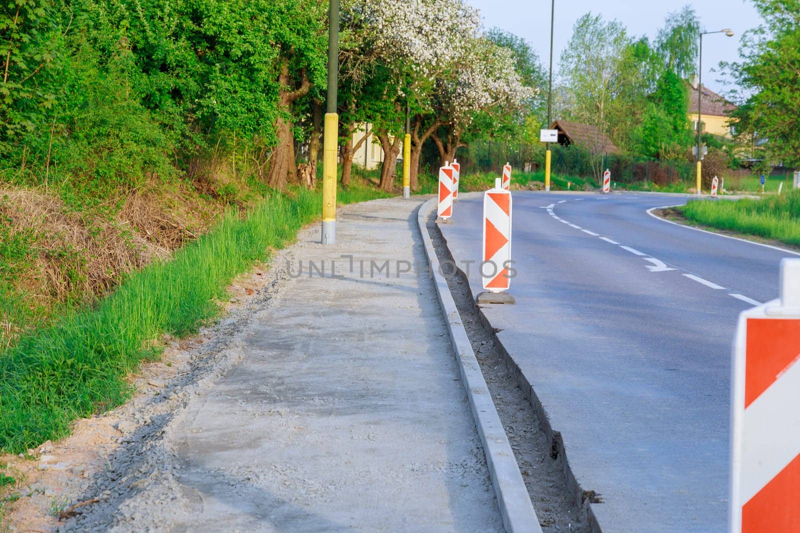 Repair of the road, installation of curbs near the carriageway and filling of pits with crushed stone.