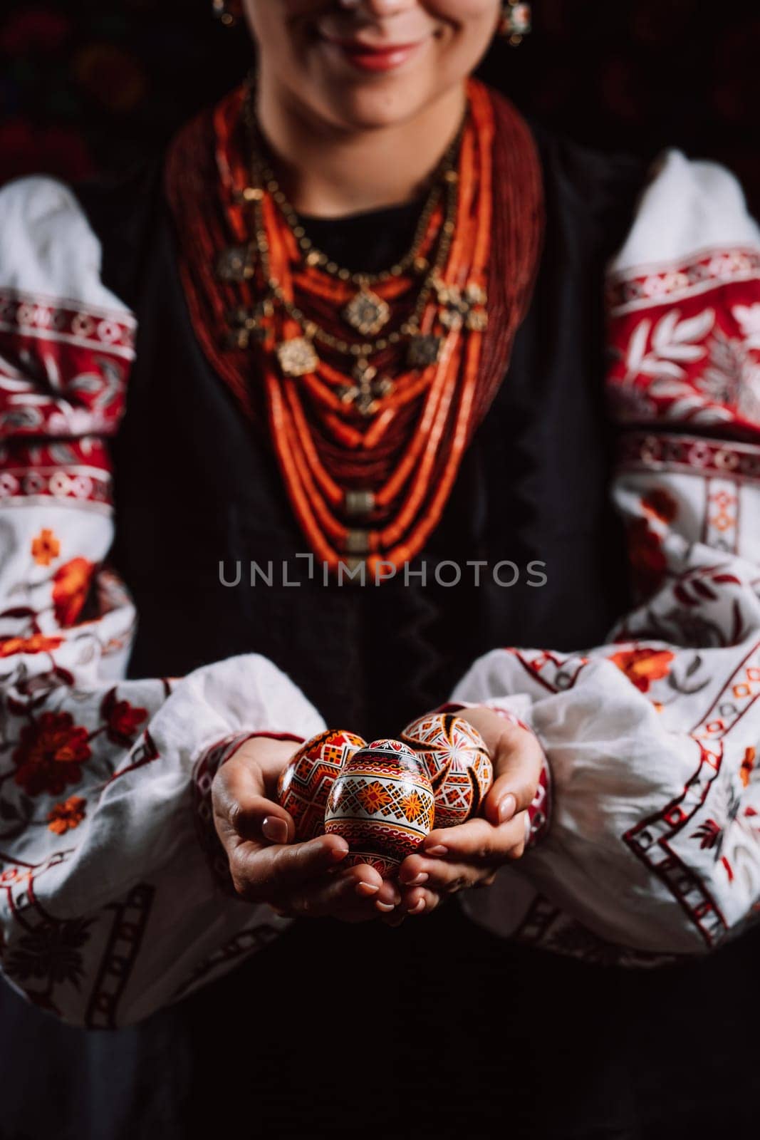 Ukrainian woman hand painted Easter eggs. Beautiful geometric slavic decoration. Lady in embroidery vyshyvanka dress. High quality photo