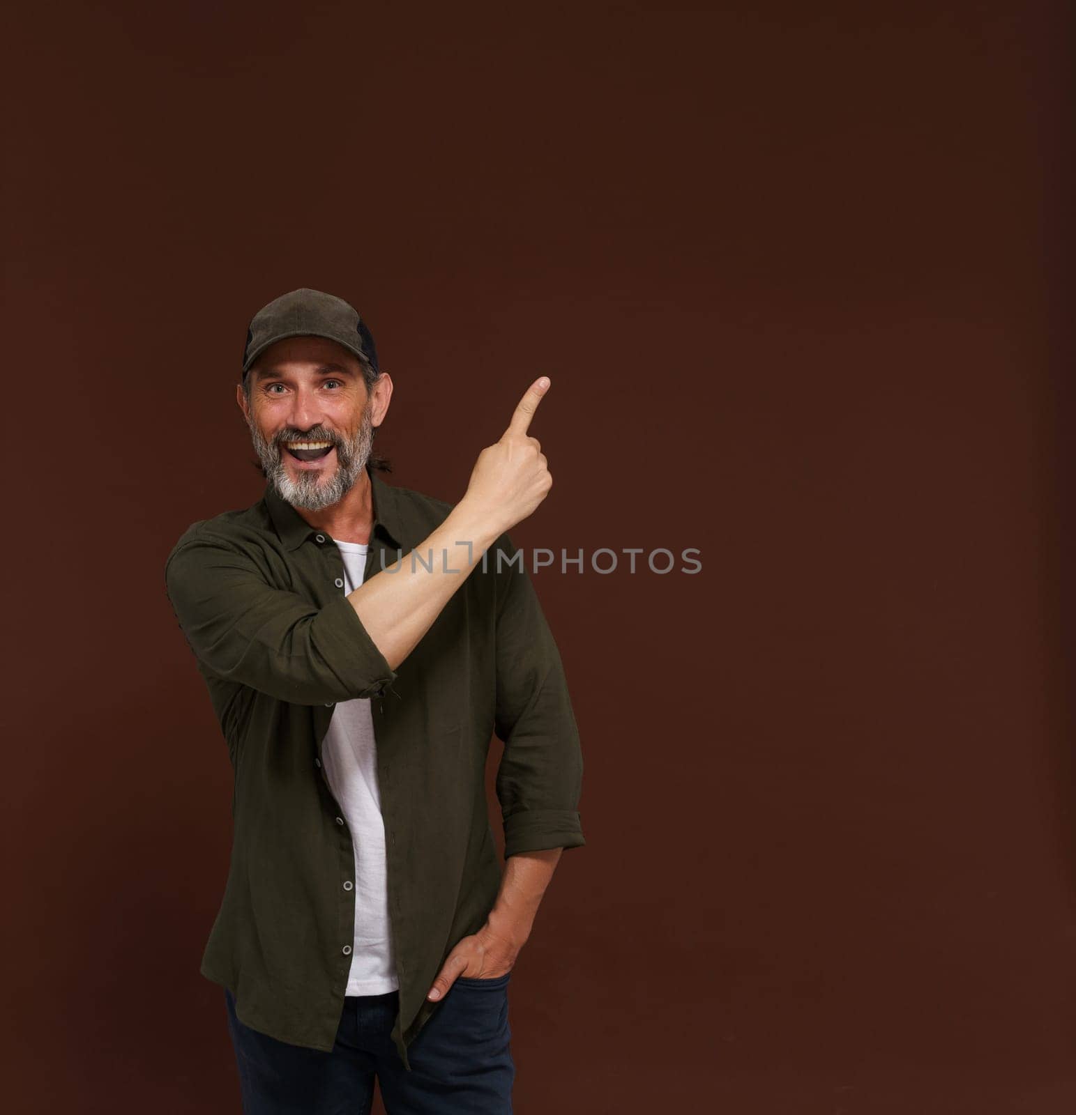 Advertising concept, mature European caucasian man pointing his finger to side. Hunter advertising concepts, marketing strategies, business communication scenario. High quality photo