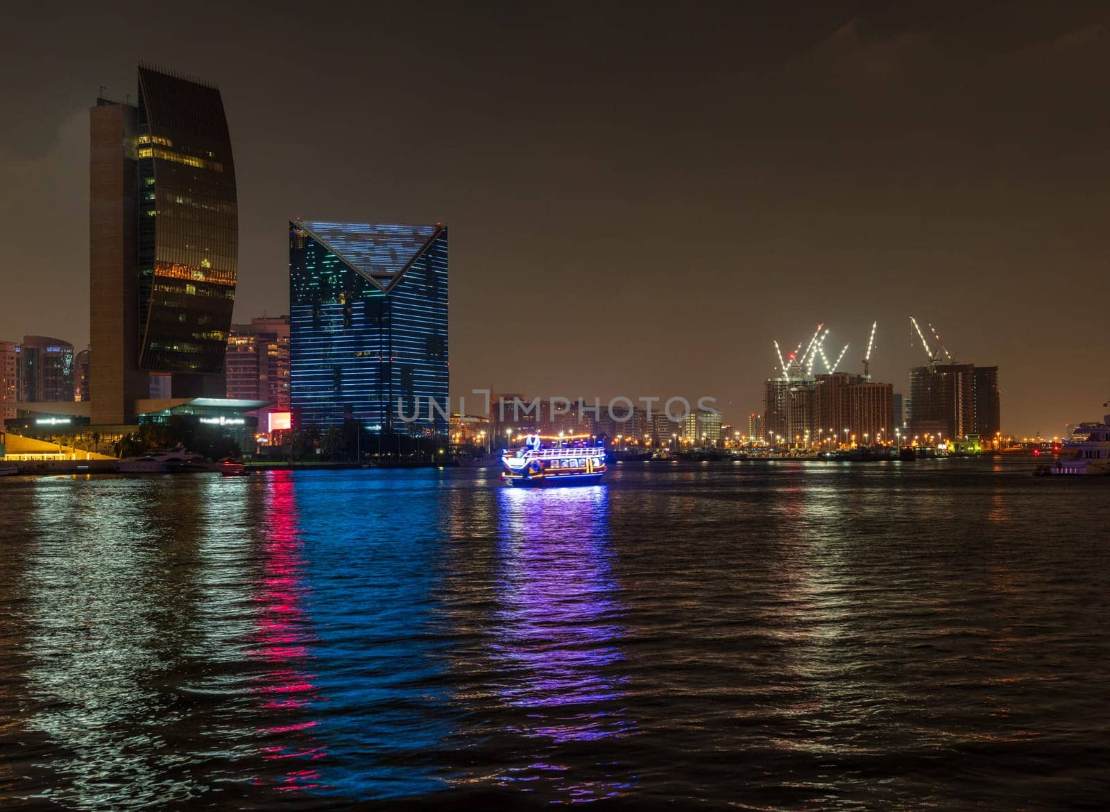 View down the Creek towards Deira as tour boats pass along the water in Dubai, UAE