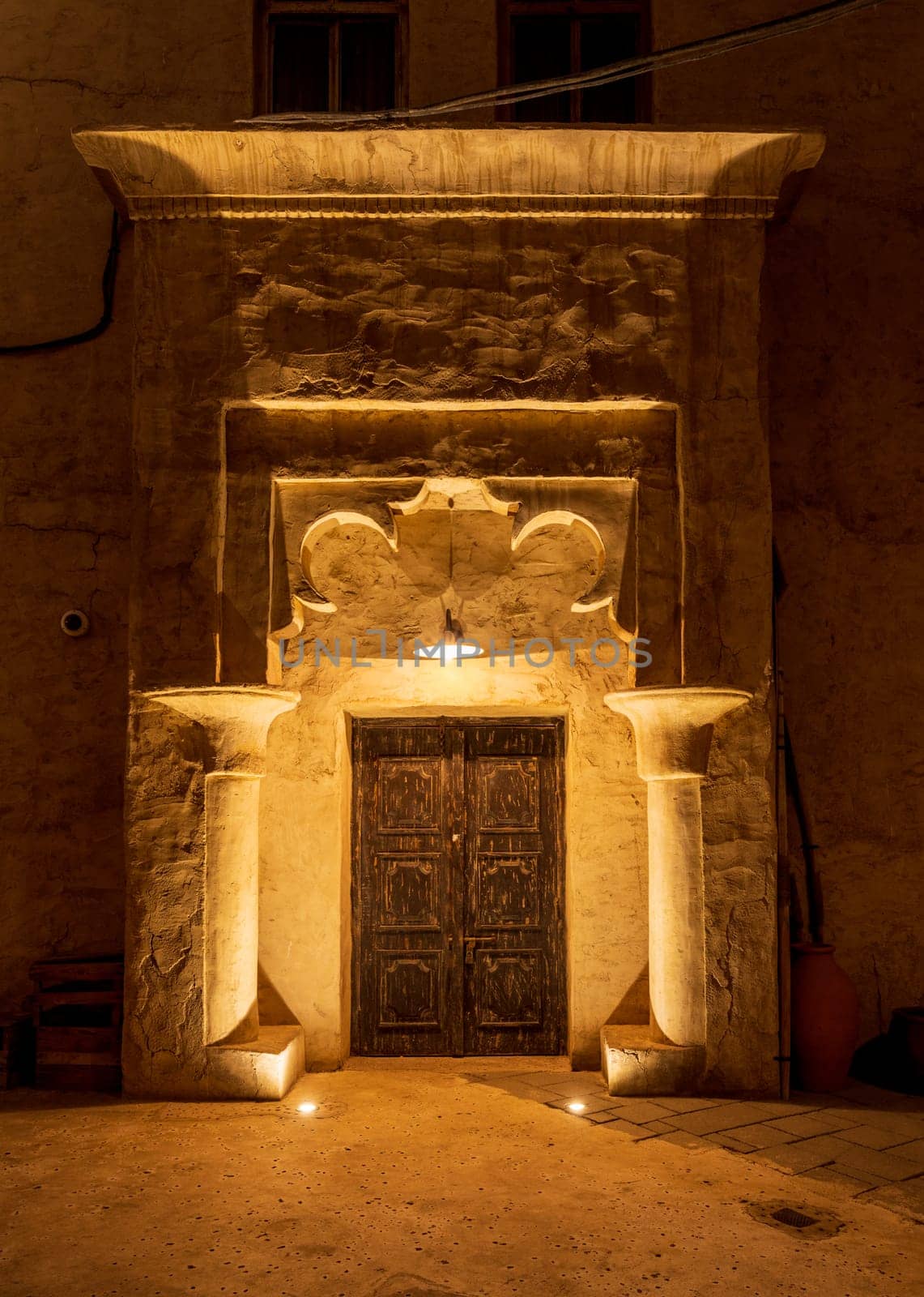 Old buildings and doorways in the Old City in Al Seef are illuminated in the evening by steheap