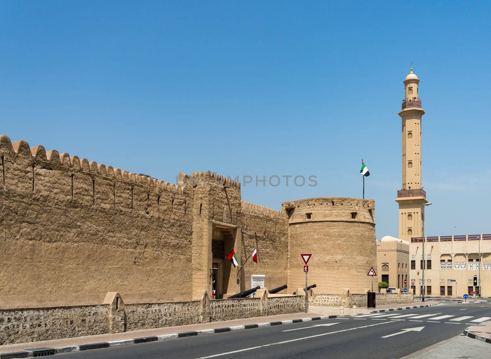 Entrance to the old fortress housing the museum in Bur Dubai with mosque in background