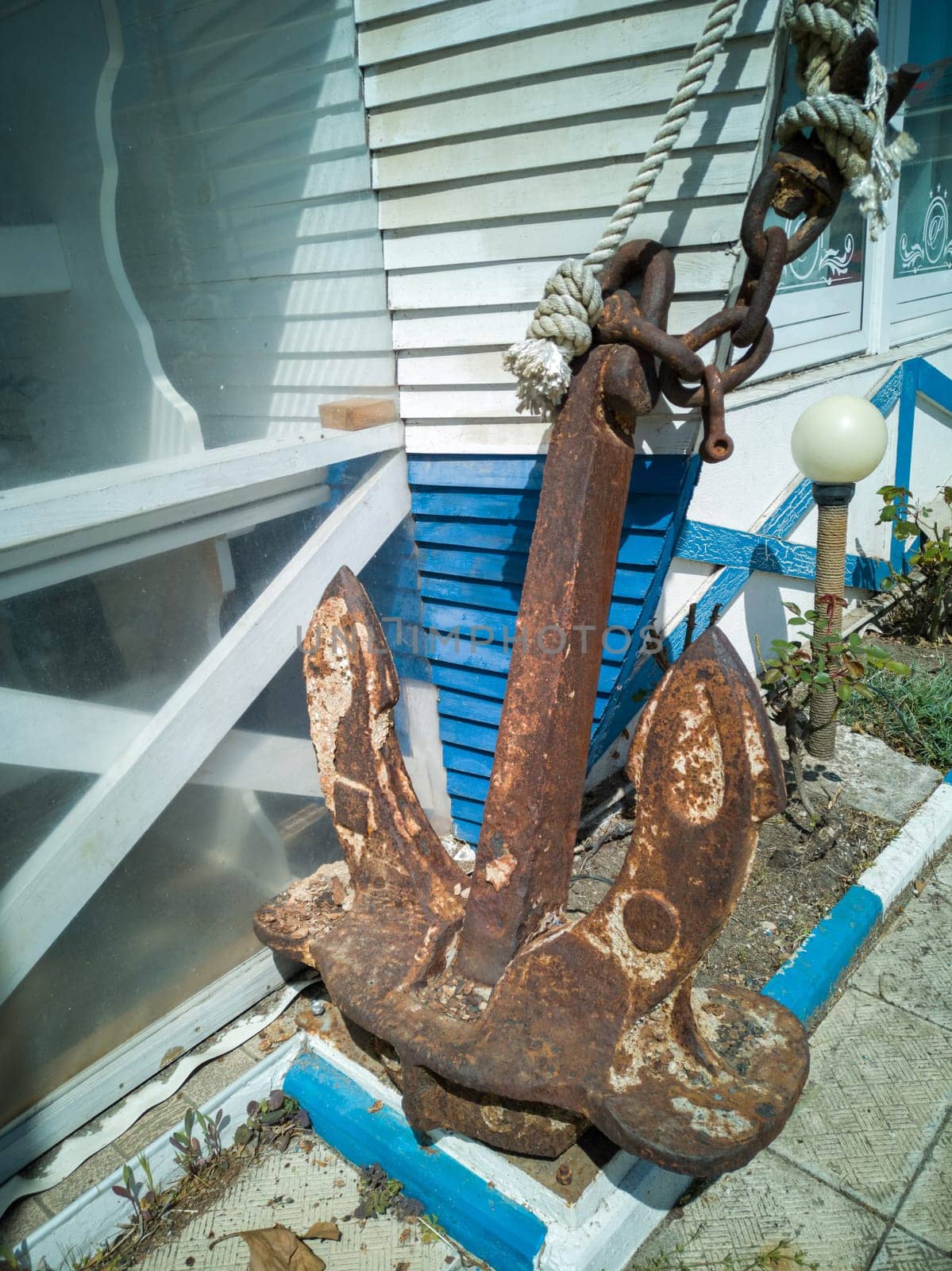 Old abandoned rusty iron ship anchor.