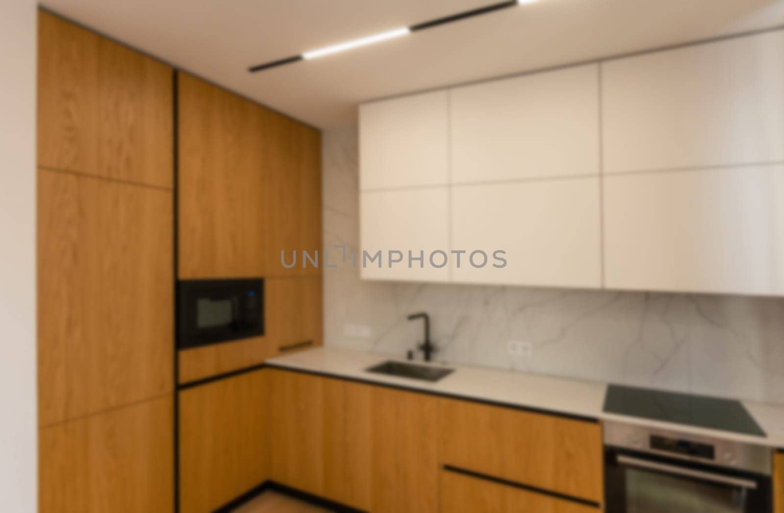 Blurred view of modern kitchen interior with white furniture. High quality photo