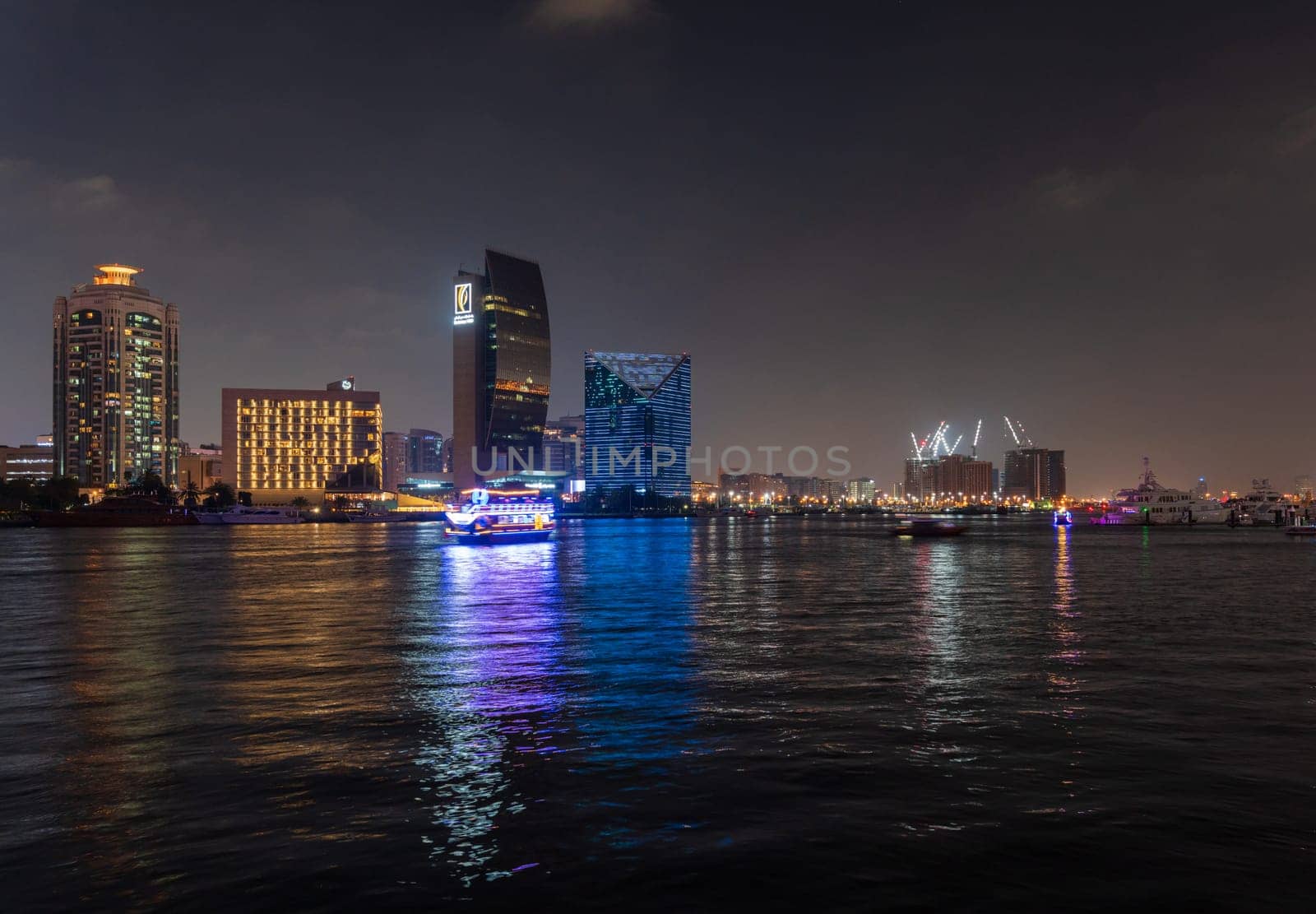 Dubai, UAE - 30 March 2023: View down the Creek towards Deira as tour boats pass along the water