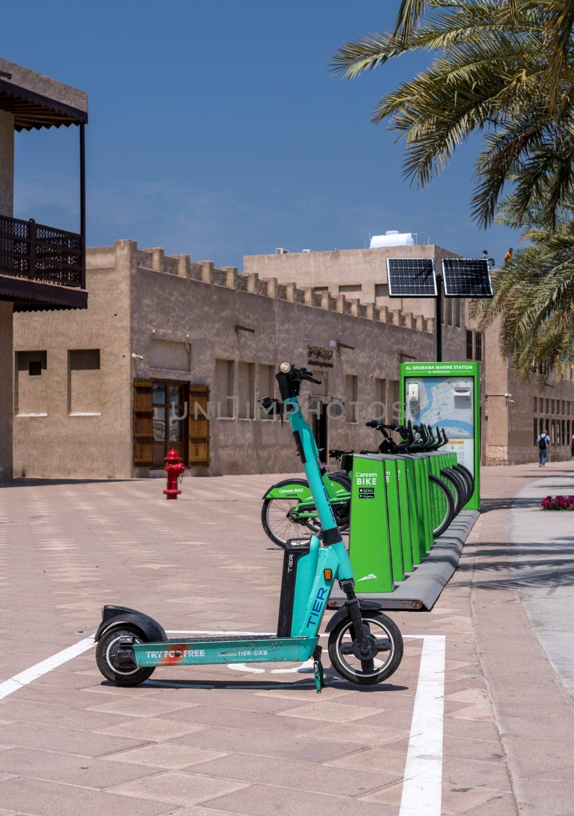 Dubai, UAE - 31 March 2023: Careem bike rental and Tier scooter in Al Shindagha district and museum in Bur Dubai