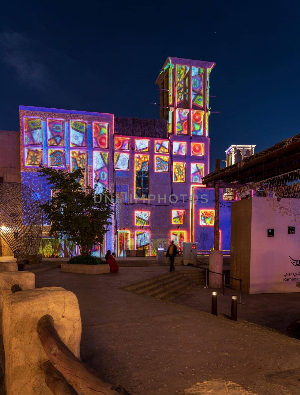 Ramadan in Dubai sign as old buildings are illuminated in the evening by steheap