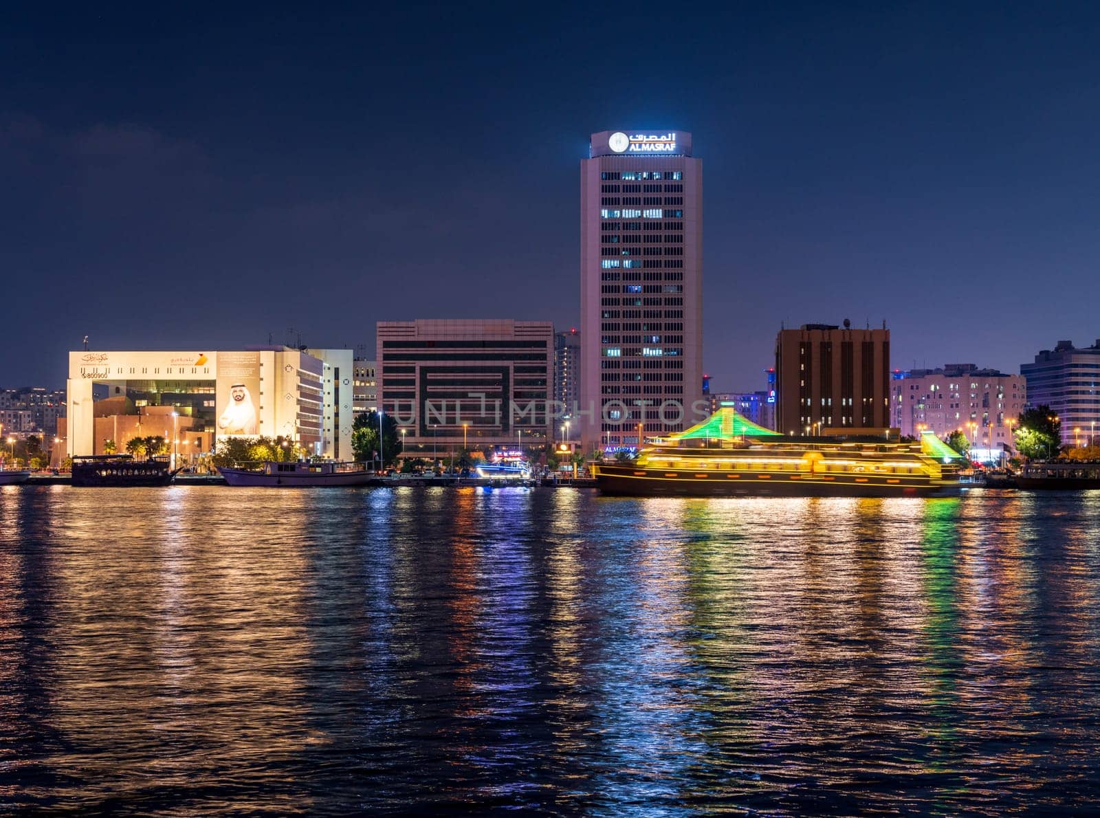 Dubai, UAE - 30 March 2023: View across the Creek towards Deira as tour boats pass along the water