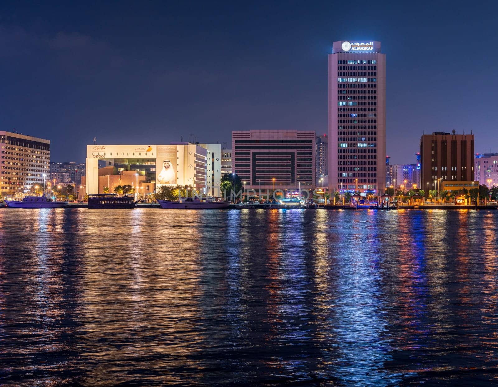 Dubai, UAE - 30 March 2023: View across the Creek towards Deira as tour boats pass along the water