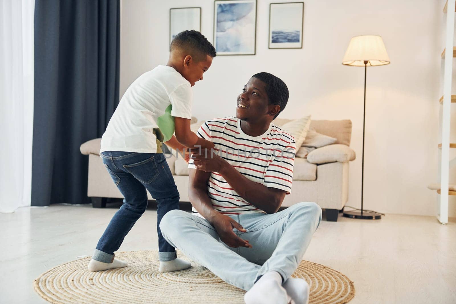 African american father with his young son at home.