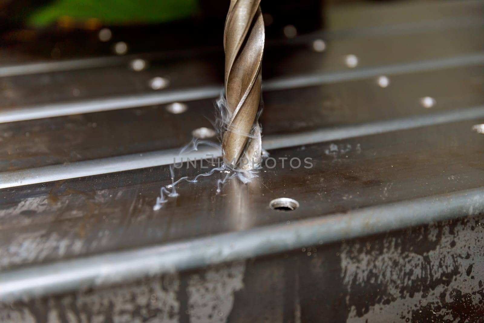 Drilling holes in metal poles for attaching various parts to the poles or connecting the poles to each other.