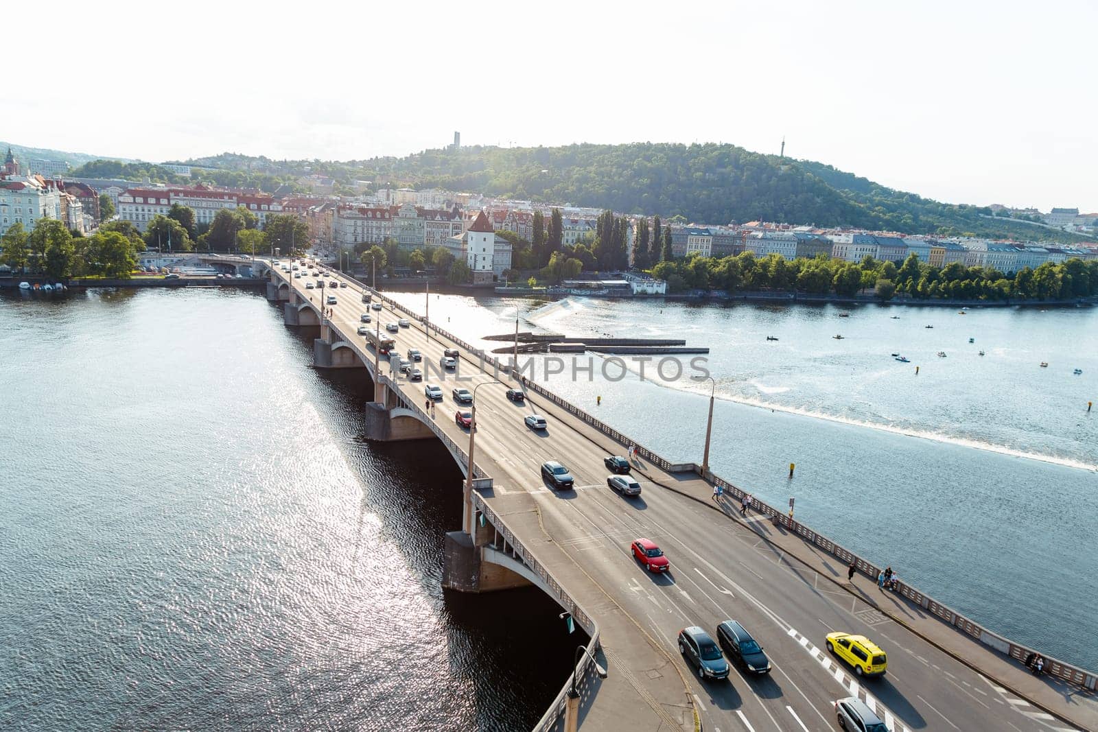 22 May 2022 Prague, Czech Republic. Traffic of cars across the bridge, the Vltava River. Panoramic view of architectural buildings, view from a height.