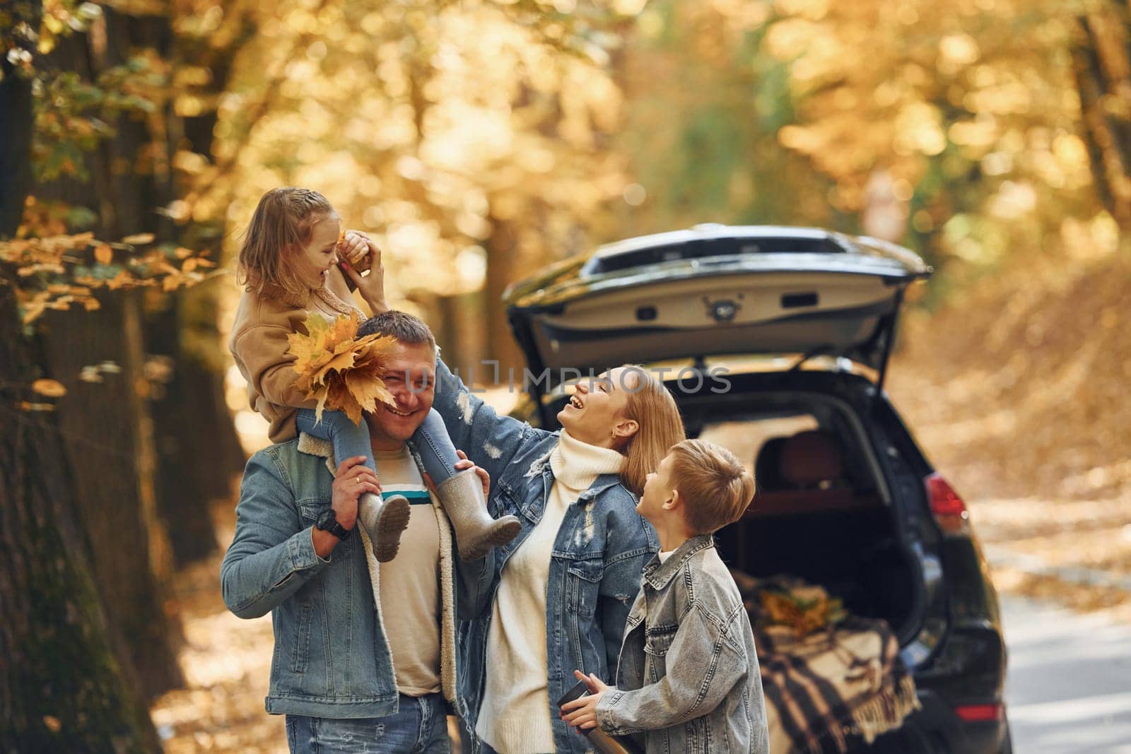 Weekend activities. Happy family is in the park at autumn time together.