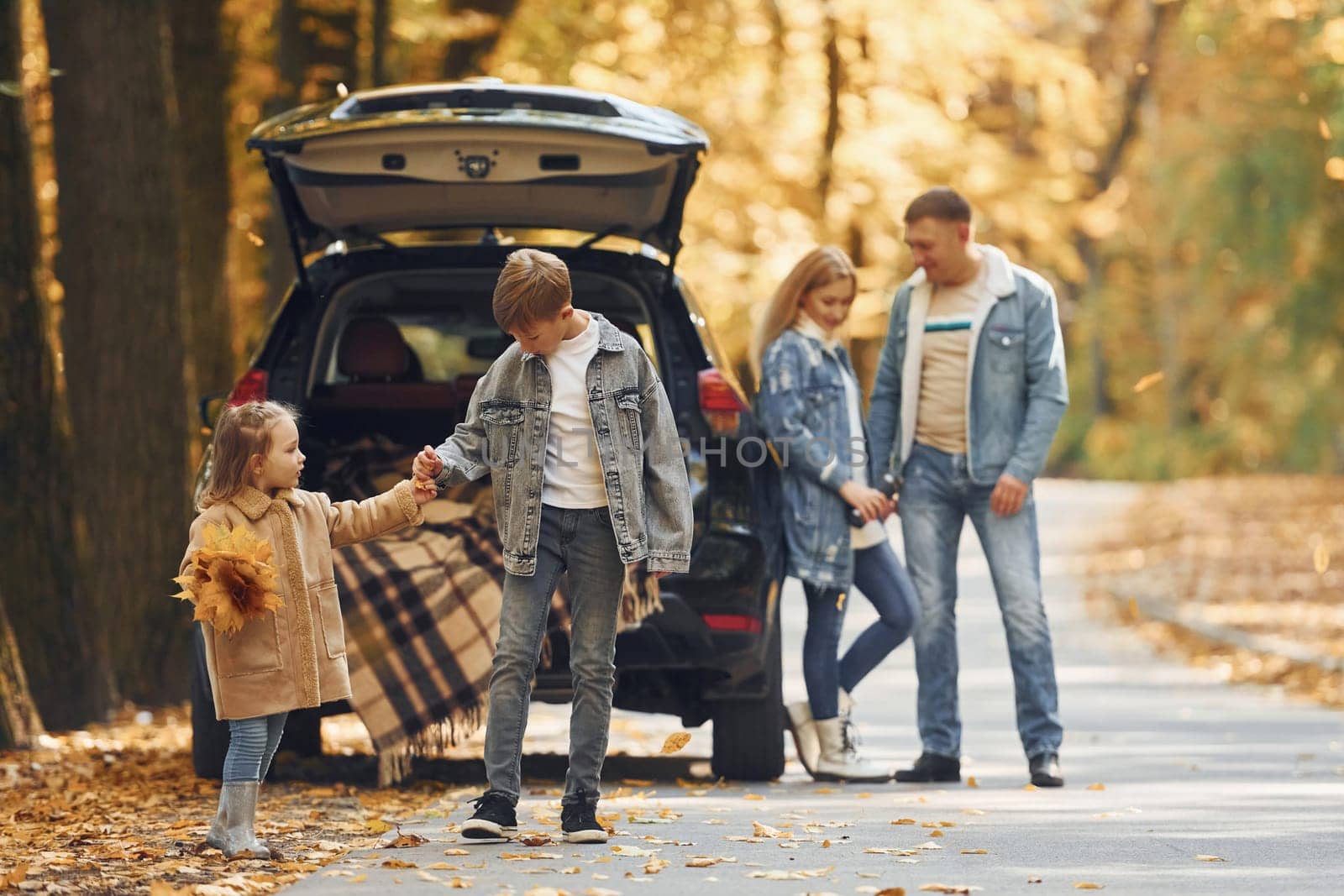 Weekend activities. Happy family is in the park at autumn time together.