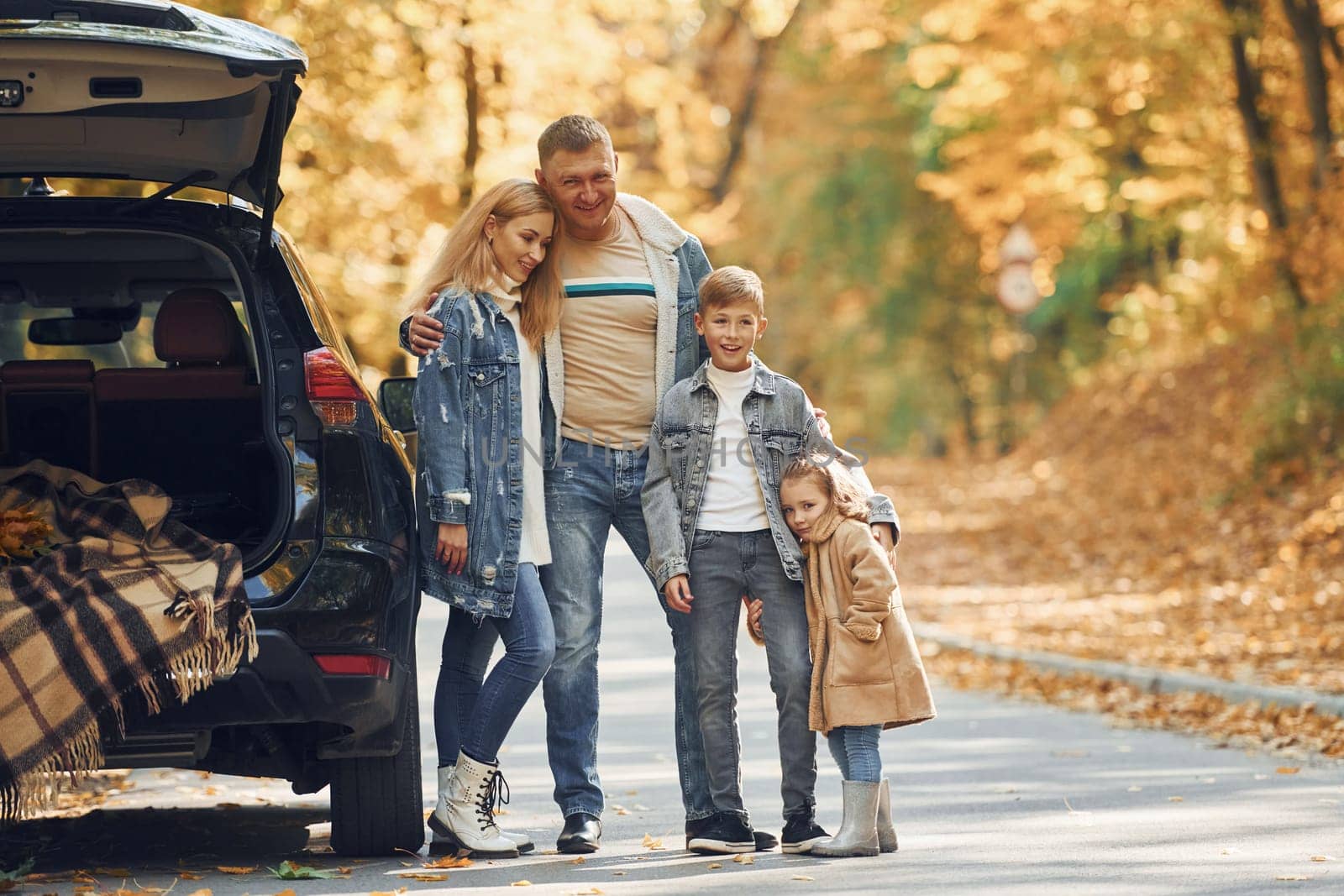Cheerful people. Happy family is in the park at autumn time together.