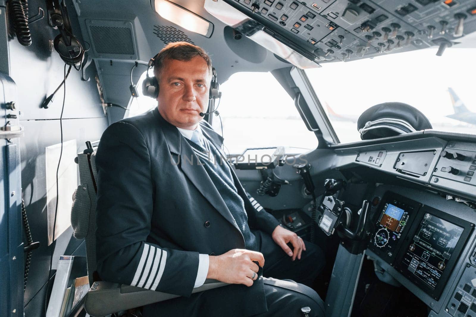 Side view. A professional pilot is in the cockpit. Conception of work.