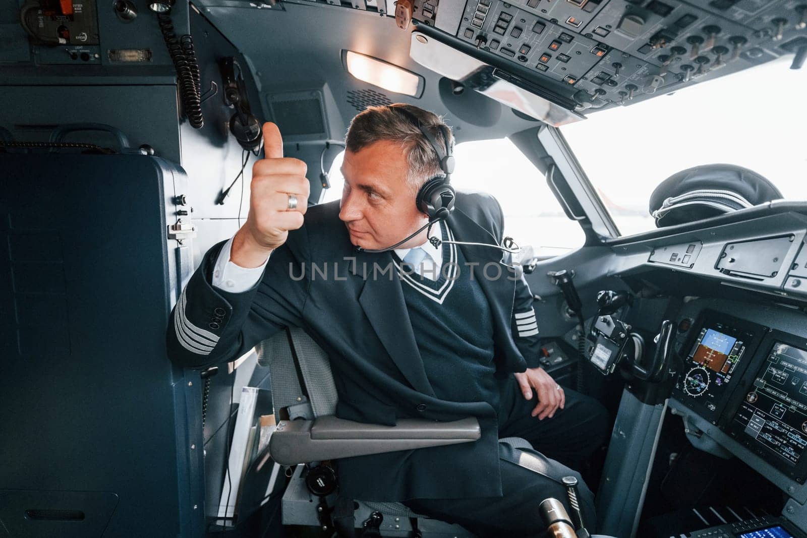 Side view. A professional pilot is in the cockpit. Conception of work.