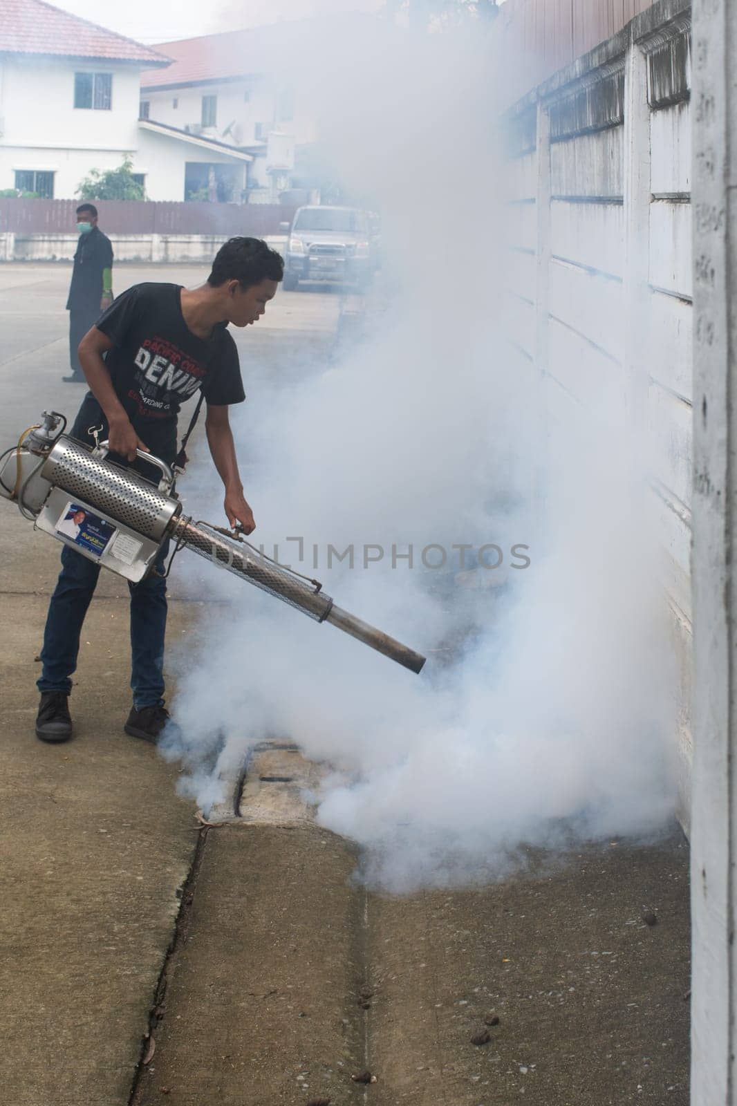 Bangkok, Thailand - July 3, 2016 : Unidentified people fogging DDT spray for mosquito kill and protect by control mosquito is a carrier of Malaria, Encephalitis, Dengue and Zika virus in village.