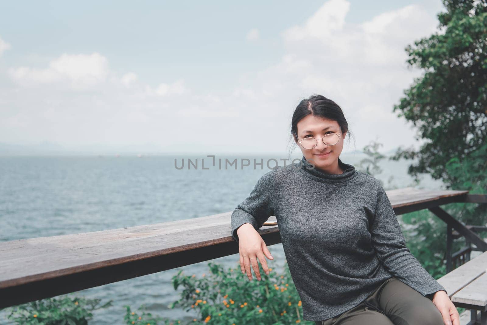 Woman (LGBTQ) posing at sea viewpoint with happy by NongEngEng