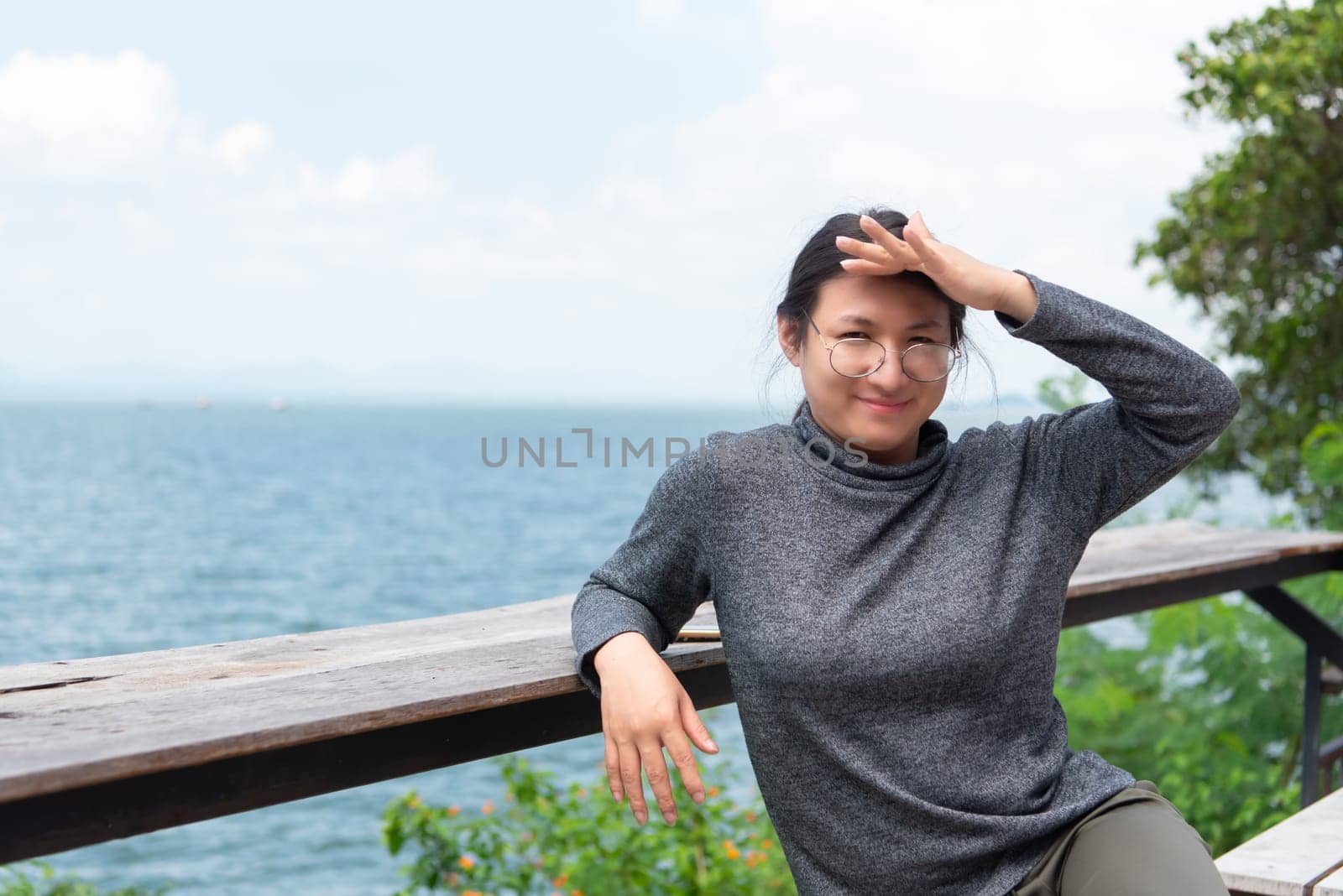 Woman (LGBTQ) posing at sea viewpoint with happy by NongEngEng