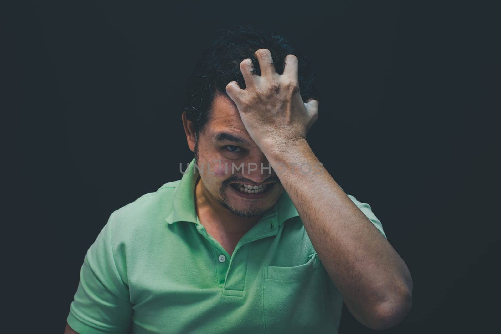 Asian man 40s strain have a anger unhappy gesture with stressed and problems concept on black background dark style