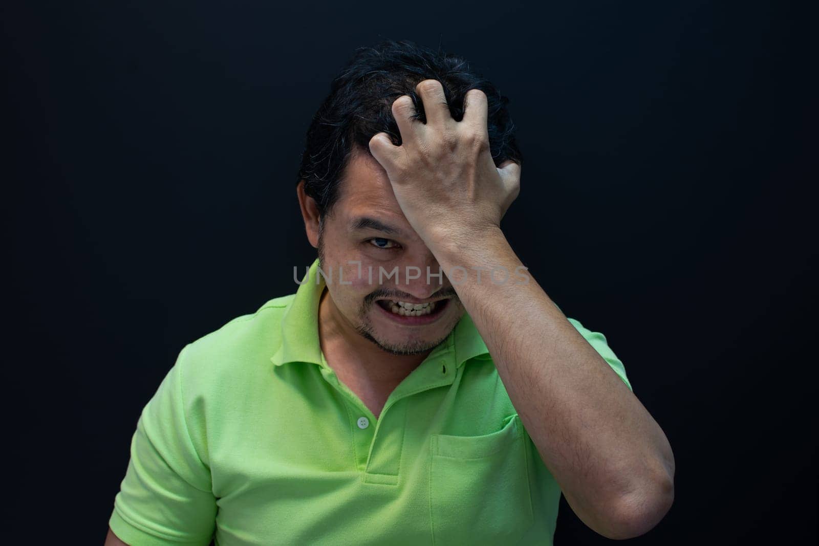 Asian man 40s strain have a anger unhappy gesture with stressed and problems concept on black background dark style