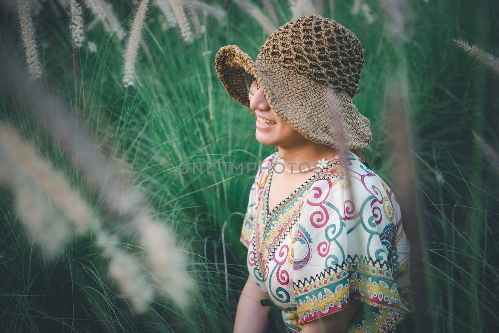 Beautiful asian woman (LGBTQ) natural makeup wear fashion relax clothes posing at nature of flower park or flower garden field lush growing for travel popular landmark in asia outdoor fashion style