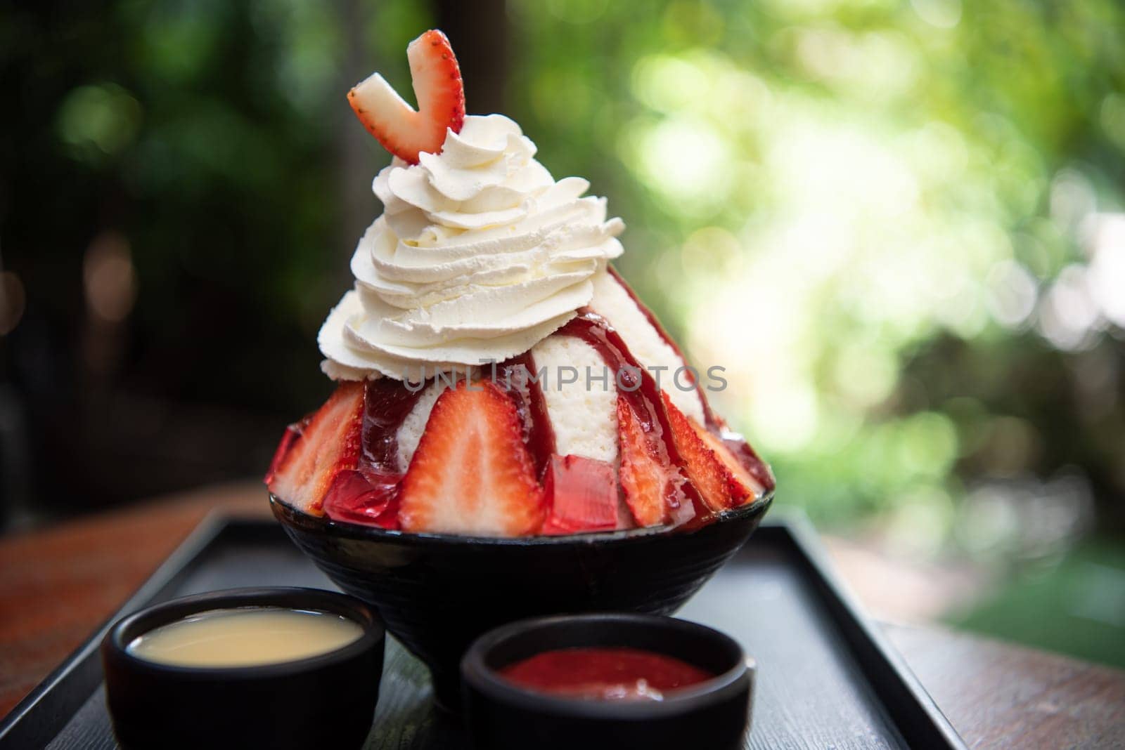 Bingsu or Bingsoo (Patbingsu) is a popular Korean shaved ice dessert with sweet toppings that may include chopped fruit, condensed milk, fruit syrup, and varieties with ingredients