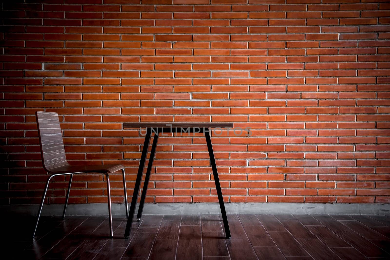 Balcony with red brick wall and table chairs set by PongMoji