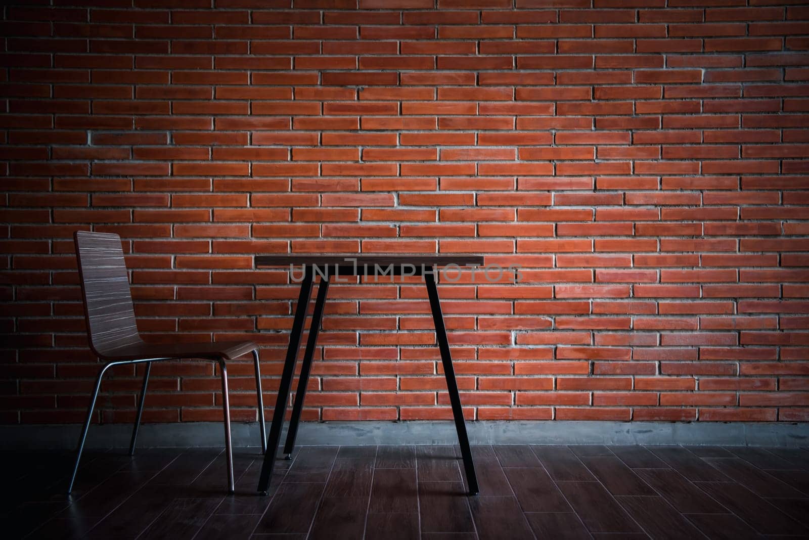 Balcony with red brick wall and table chairs set by PongMoji